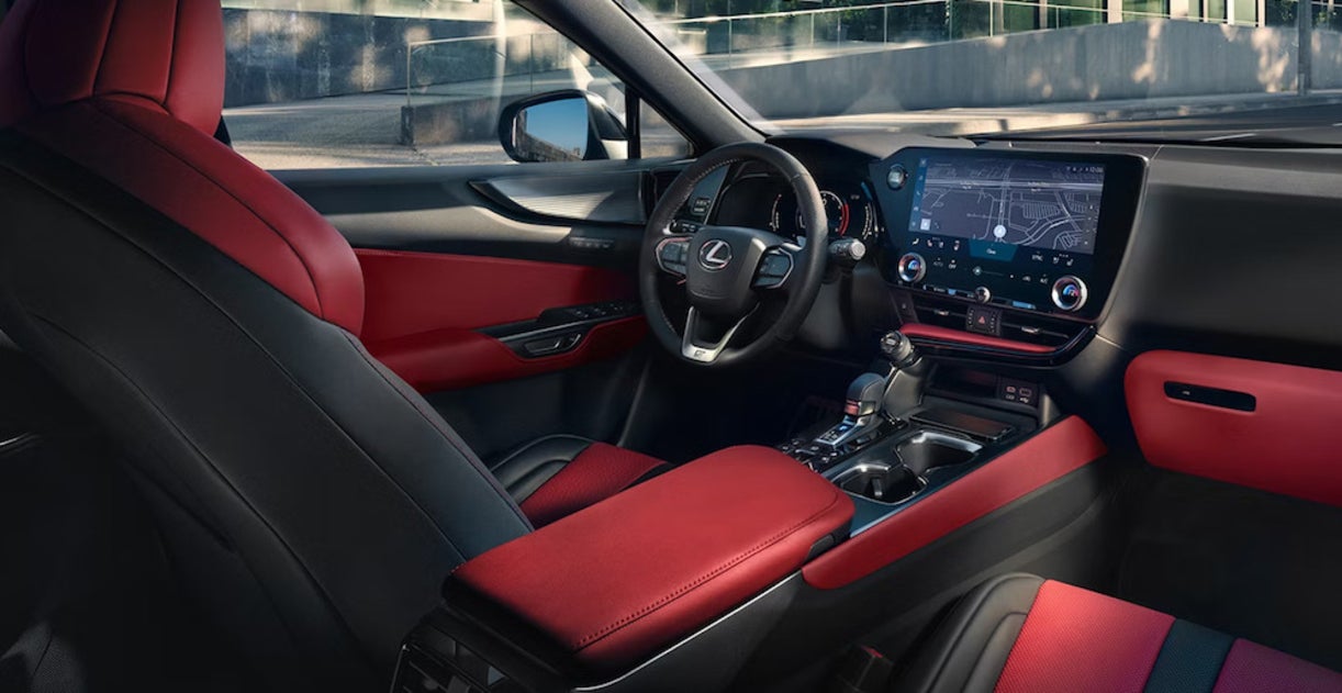 The interior of the 2026 Lexus NX, featuring red and black upholstery, leather-wrapped steering wheel, and touchscreen display