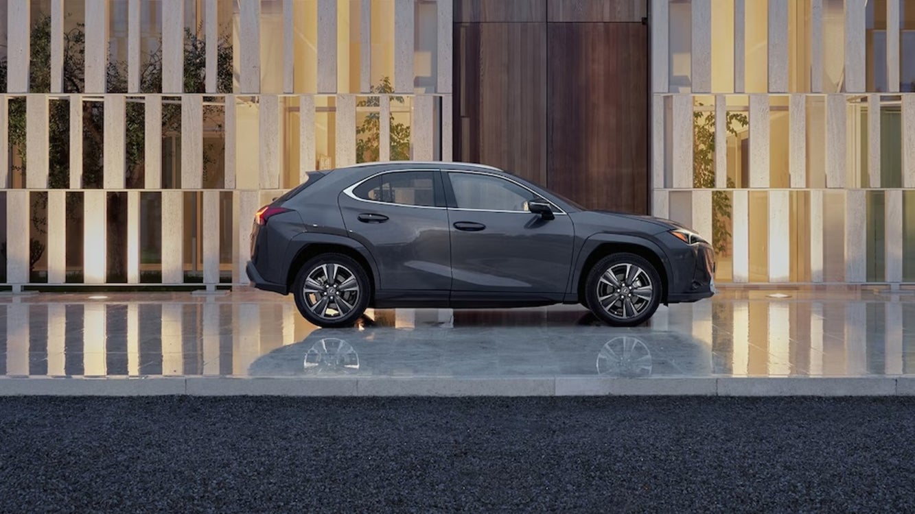 A side view of a gray 2026 Lexus UX luxury crossover SUV